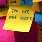 yellow sticker written you are not alone